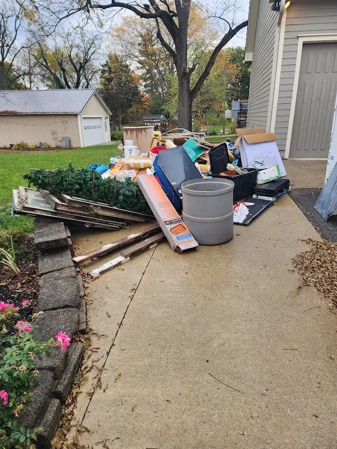 Dumpster being loaded with debris for 30 Yard Dumpster Rental in American Falls